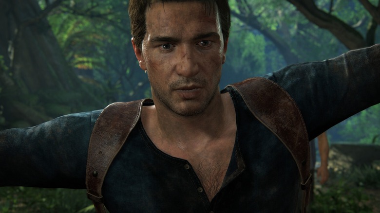 A disheveled Nathan Drake stands in a jungle in Uncharted: Legacy of Thieves Collection