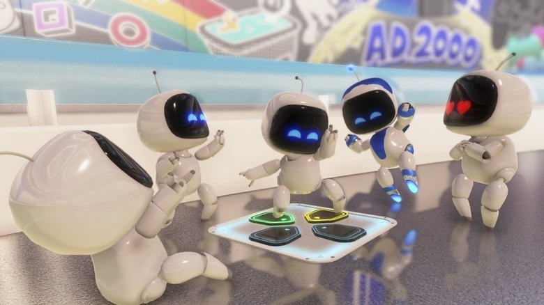 A group of bots dance on a D-Pad in Astro's Playroom