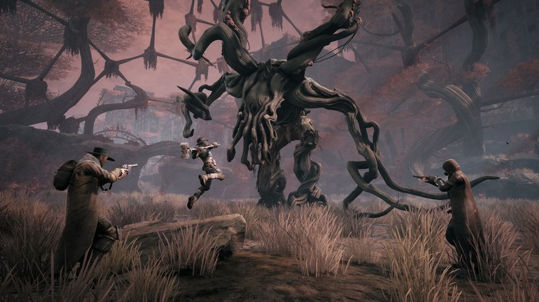 Three hunters attack a gnarled monster in Remnant: From the Ashes