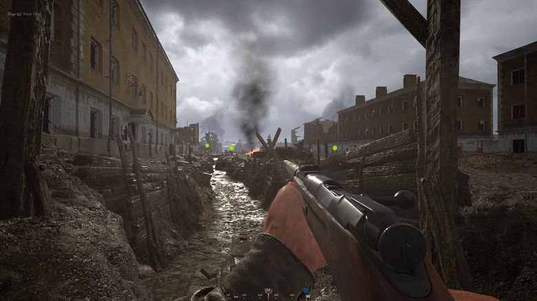 A soldier points a rifle down a trench in Hell Let Loose