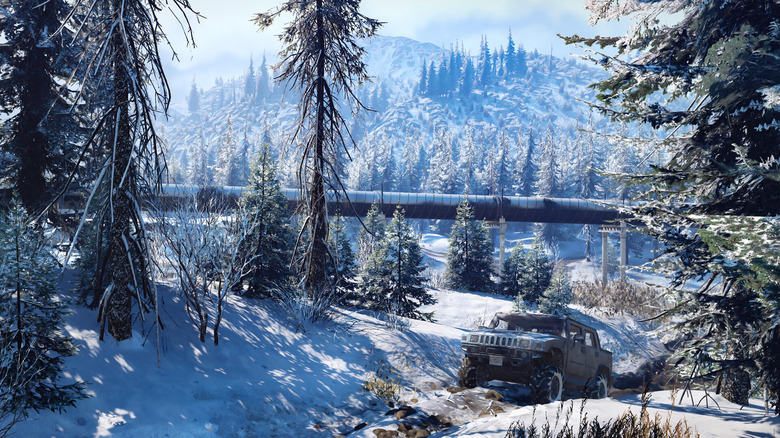 A Hummer drives next to a pipeline in a wintry forest in SnowRunner