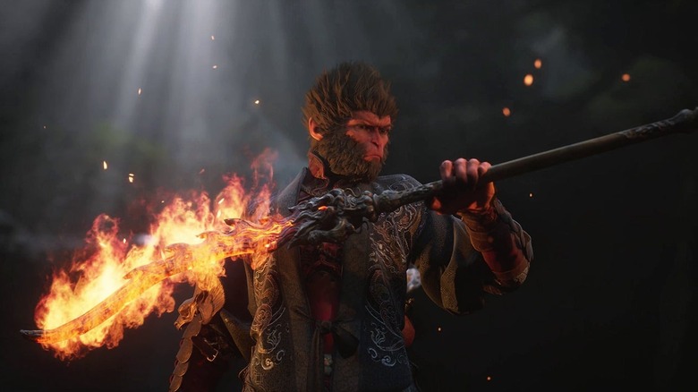 The Destined One holds a flaming staff in Black Myth: Wukong