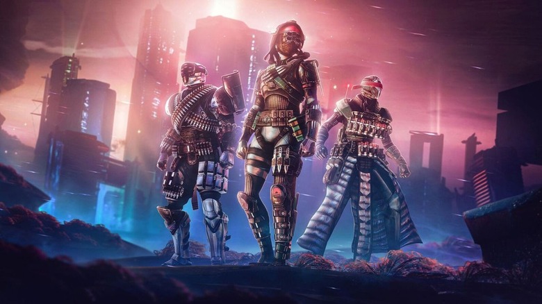 Three Guardians stand in front of a futuristic city on promotional artwork for Destiny 2