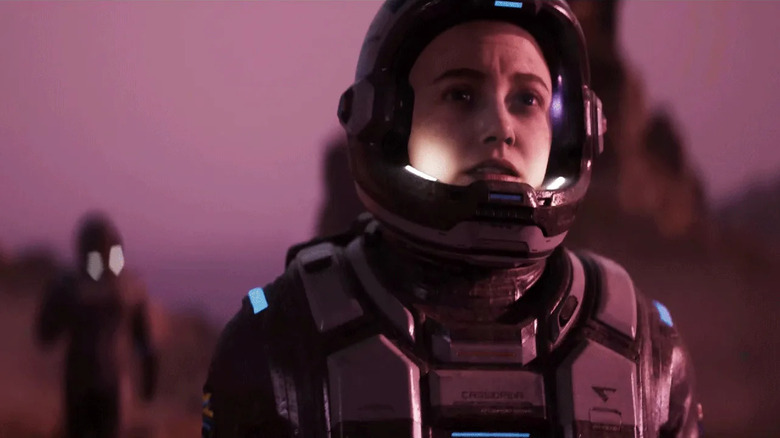 A woman in a spacesuit stands on a planet surface in Directive 8020