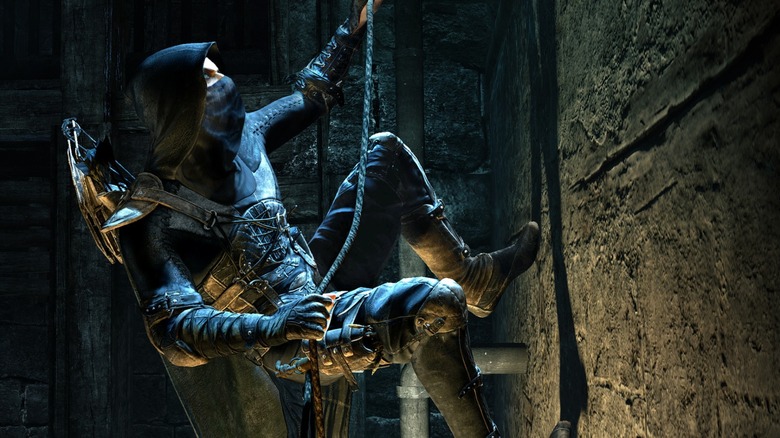 The titular thief in full costume scaling a wall with a grapple