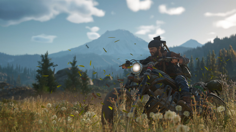 Deacon St. John riding a motorcyle through a field