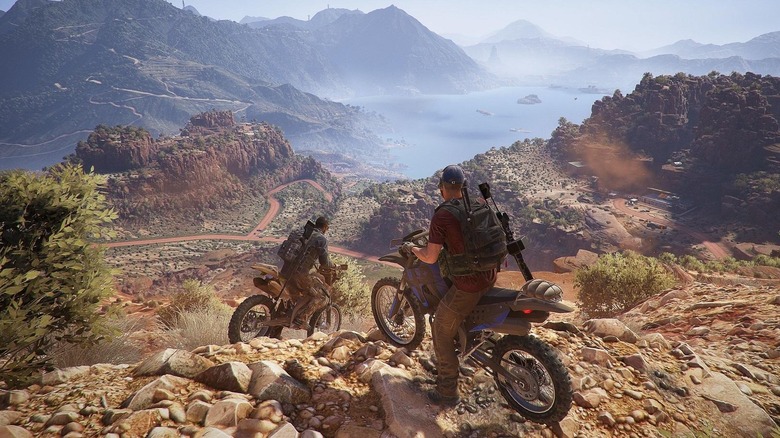 Two soldiers ride dirt bikes over a ridge in "Tom Clancy's Ghost Recon Wildlands" (2017)