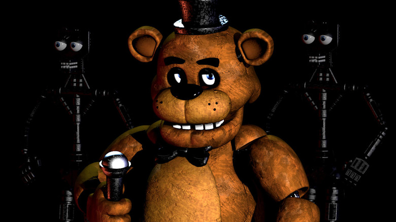 Freddy Fazbear stands on a darkened stage in Five Nights at Freddy's