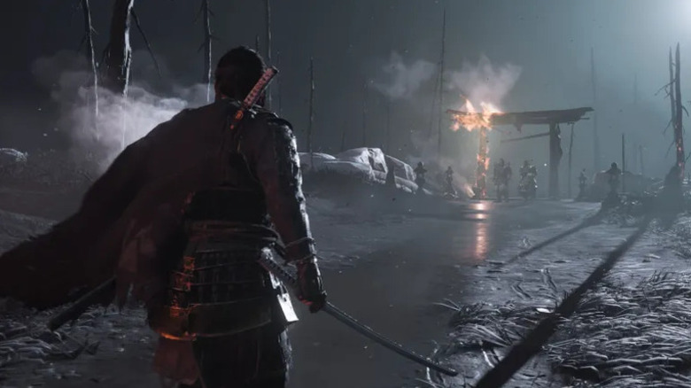 Jin Sakai approaches warriors under a burning Tori gate with his sword drawn in "Ghost of Tsushima" (2020)