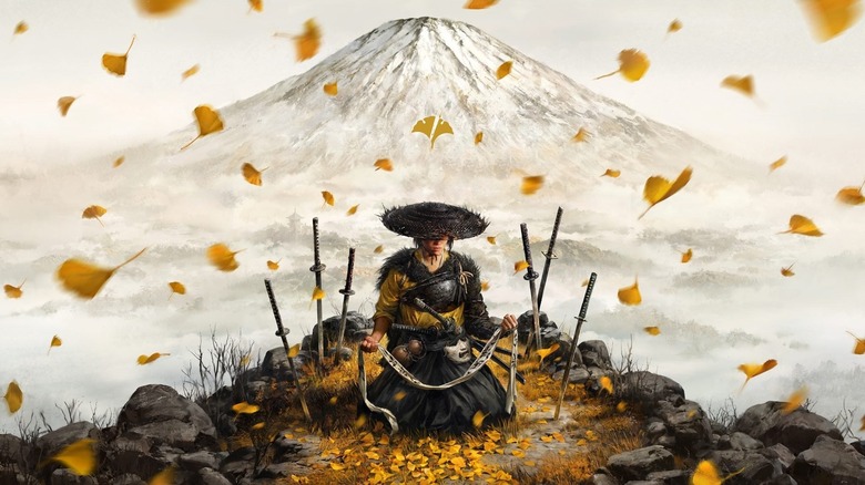 Atsu kneels surrounded by leaves and samurai swords under Mount Yōtei in "Ghost of Yōtei" (2025)