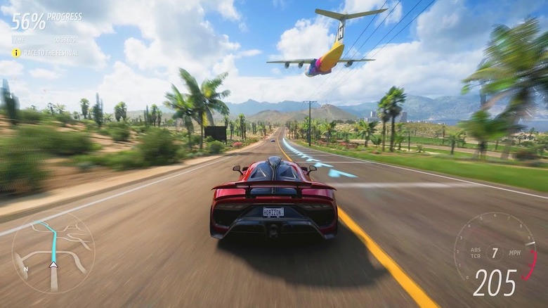 A plane flies over a sports car in Forza Horizon 5