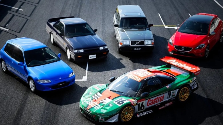 Five different cars on a racetrack in an ad for Gran Turismo 7