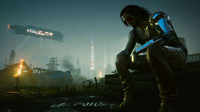 Johnny Silverhand sits near some graffiti with Night City behind him in "Cyberpunk 2077" (2020)