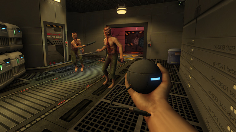 The player holds up a device implanted into their wrist while facing two mutants in System Shock 2 Remastered