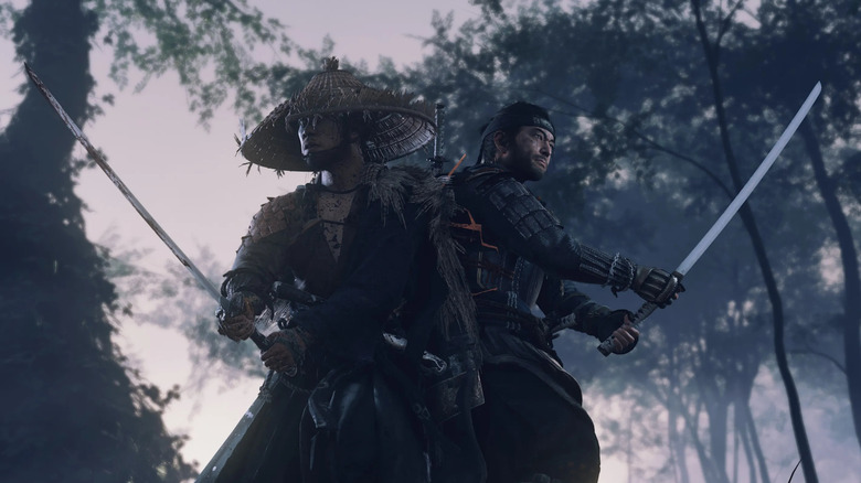 Jin Sakai stands next to another samurai with swords drawn in Ghost of Tsushima