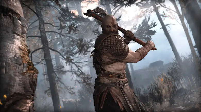 Kratos prepares to chop a tree with an ax in God of War (2018)