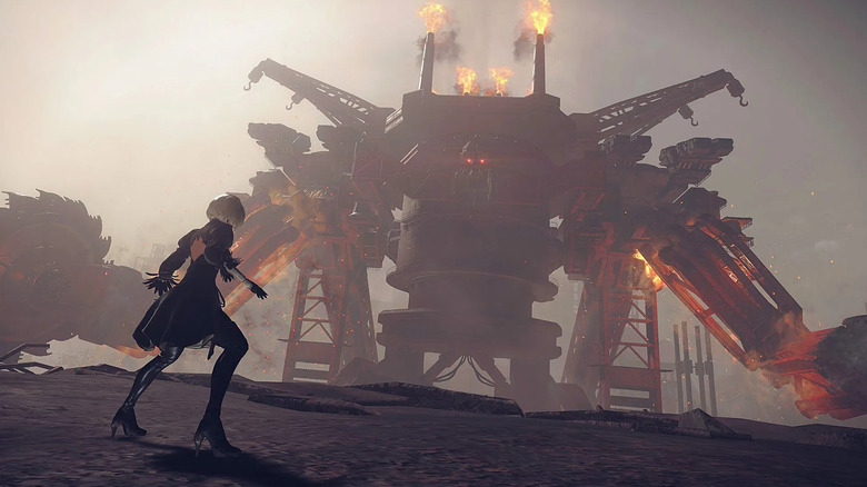 2B faces a large, fire-spewing machine in Nier: Automata