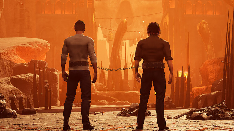 Two men survey Hell while chained together at the waist in Chained Together