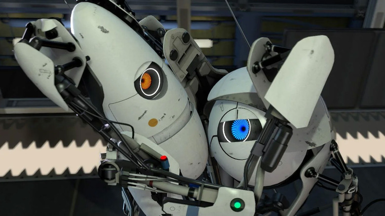 Two robots cling to each other in Portal 2