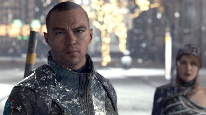 Markus stands warily in a street in Detroit: Become Human