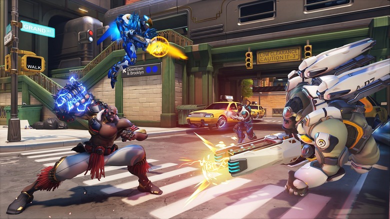 A group of futuristic fighters battle in a city street in Overwatch (2023)