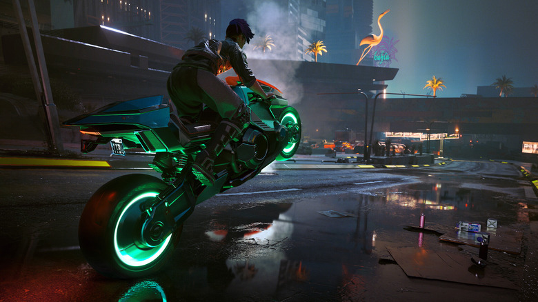 V driving a green-lit motorcycle in the streets of Cyberpunk 2077