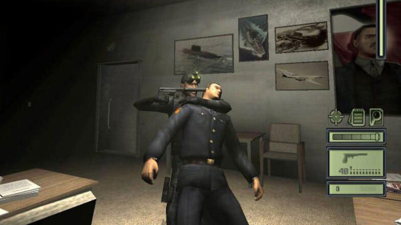 Sam Fisher holds a pistol to a man's head in Splinter Cell