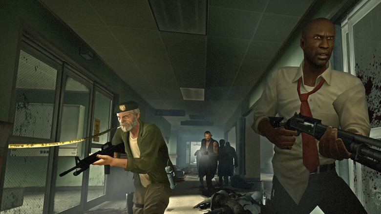 A group of survivors walk down a hallway in Left 4 Dead