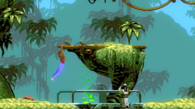 Conrad Hart clings to a tree branch in a jungle in Flashback (1992)