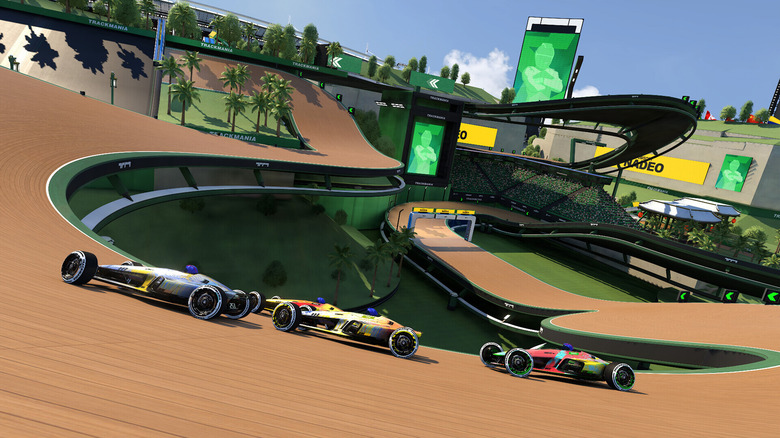 Three racers in Trackmania speeding around a track