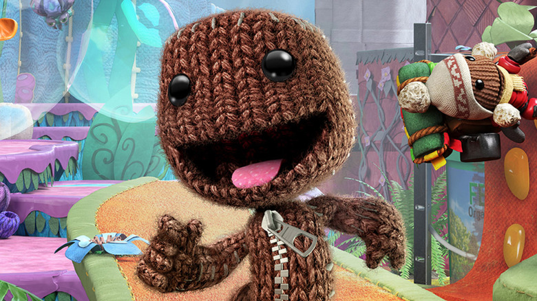 Sackboy walks happily on the cover art for Sackboy: A Big Adventure