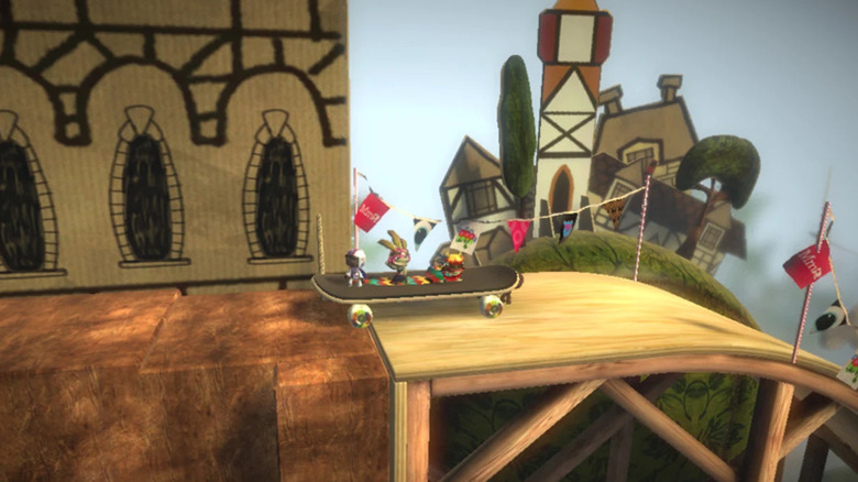Three Sackboys ride a skateboard in LittleBigPlanet