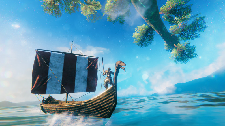 A Valheim player sailing a ship across a blue ocean with a tree overhanging