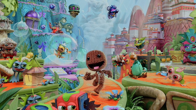 Sackboy happily strolls through Craftworld on the cover art for Sackboy: A Big Adventure