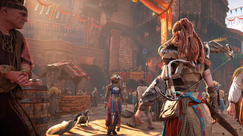 Aloy standing in front of a busy market in Horizon Zero Dawn