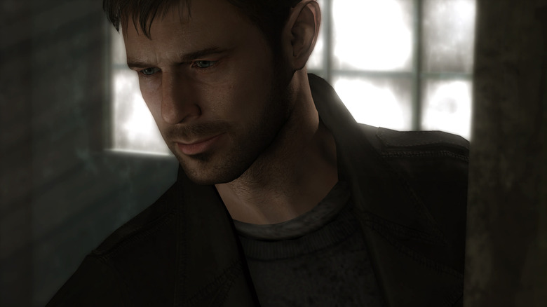 Ethan Mars looks down in a darkened room in Heavy Rain