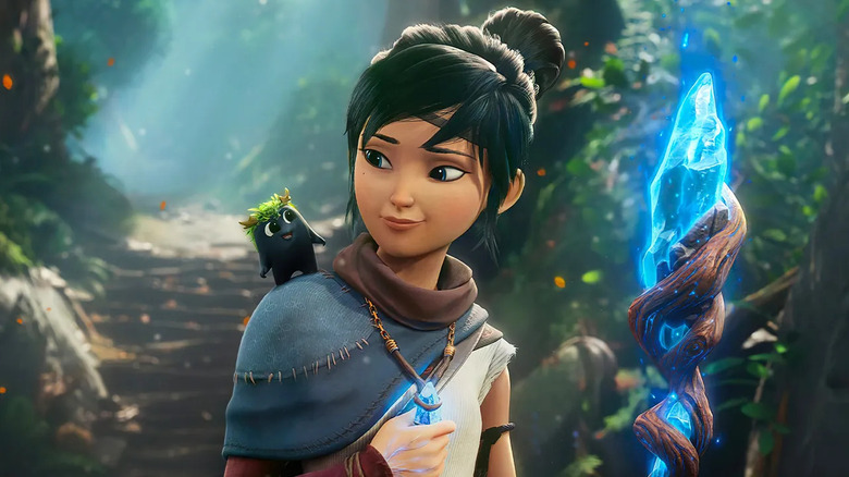 Kena looks at a Rot smiling on her shoulder on the cover art for Kena: Bridge of Spirits