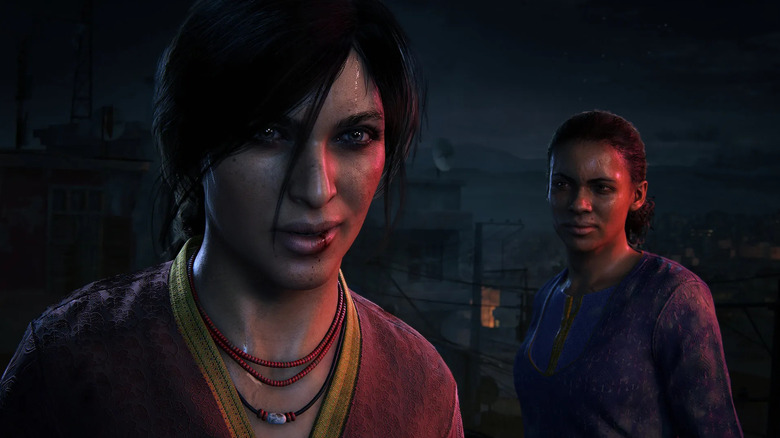 Chloe Frazer and Nadine Cross speak over a city at night in Uncharted: The Lost Legacy