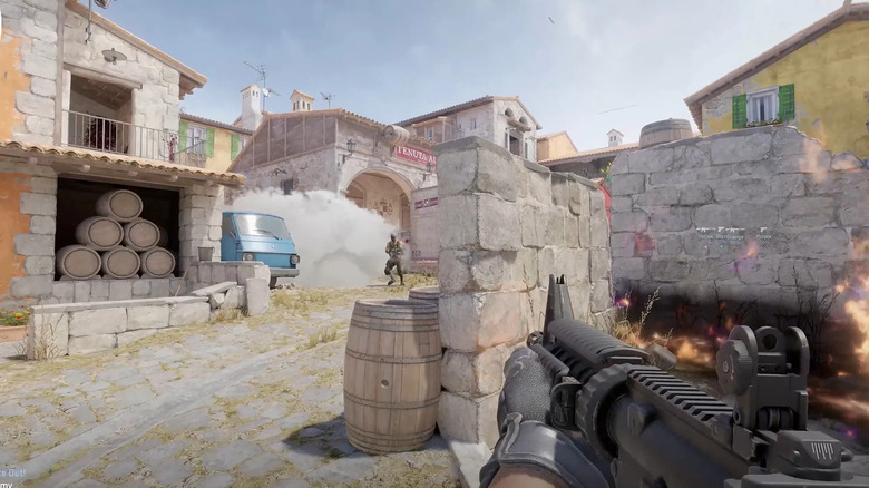 The player aims at a terrorist emerging from smoke in Counter-Strike 2
