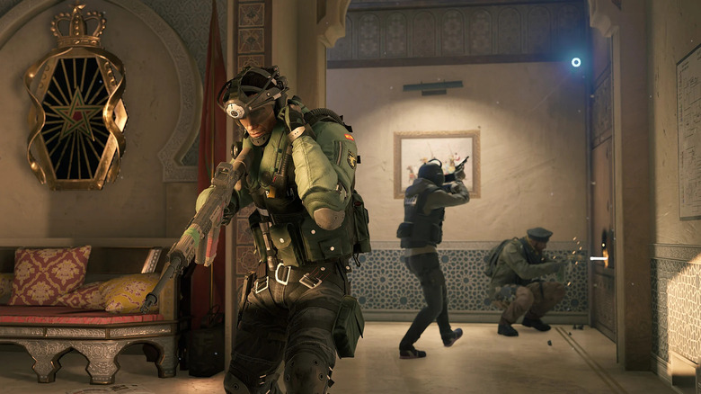 An attacking team breaches an armored door in Tom Clancy's Rainbow Six Siege