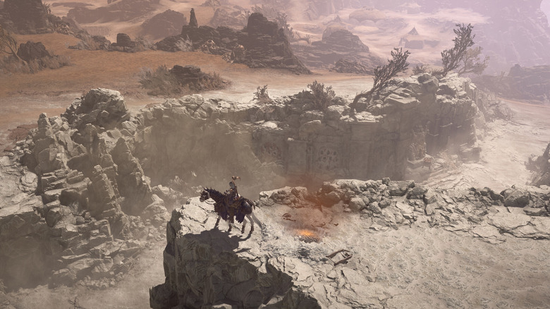 A player in Diablo 4 riding a horse in a dry valley