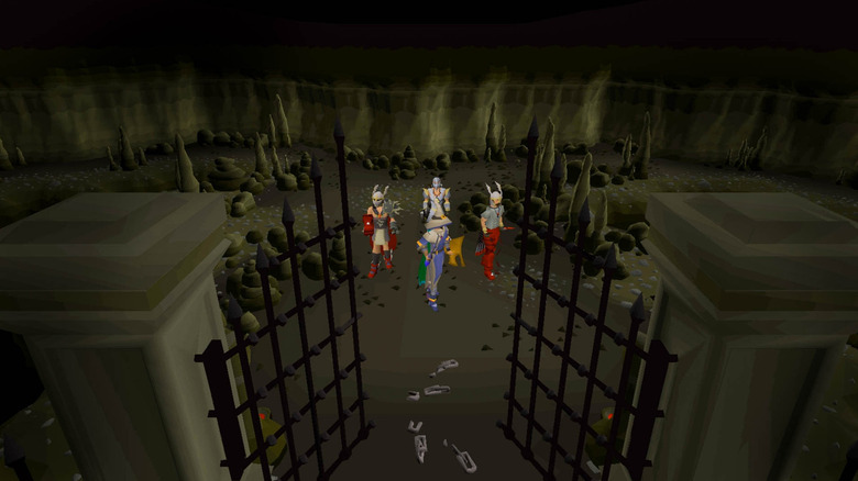 Four Old School RuneScape players standing in the middle of a dungeon
