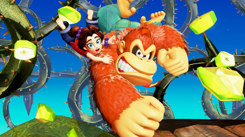 Pauline clings to Donkey Kong as he punches through a banana in Donkey Kong Bananza