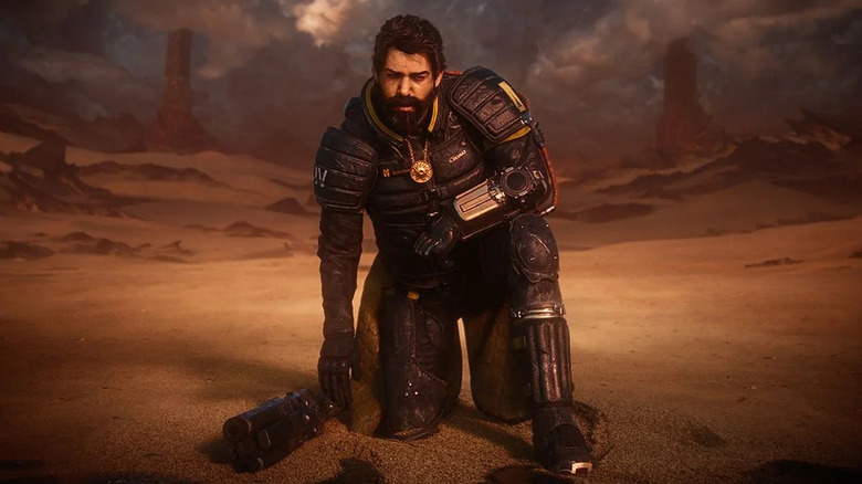 Arjun Devraj kneels in a desert in Saros