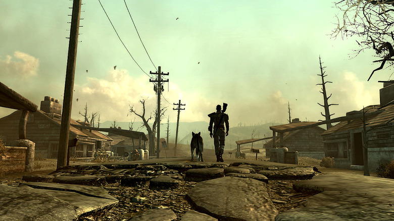 The player character and their dog walk through a ruined neighborhood in Fallout 3