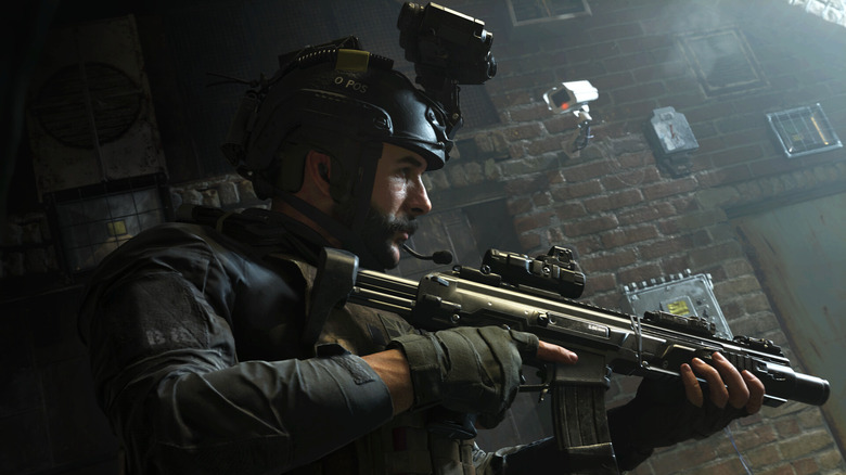 Captain John Price holds an assault rifle while walking under a security camera in Call of Duty: Modern Warfare