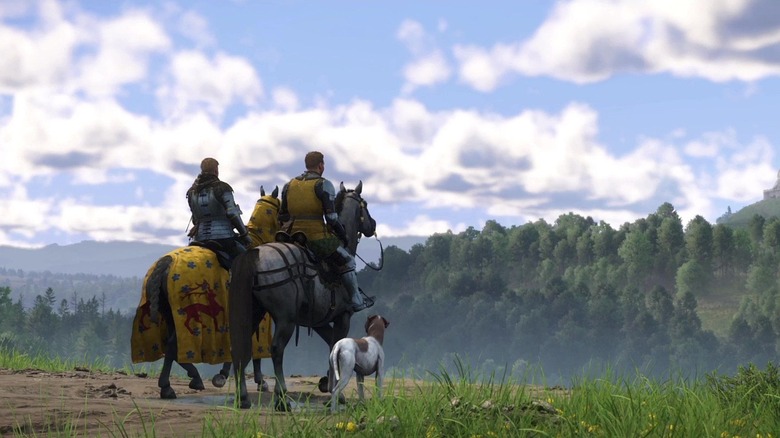 Henry, Hans, and their dog ride horses across a field in Kingdom Come: Deliverance II
