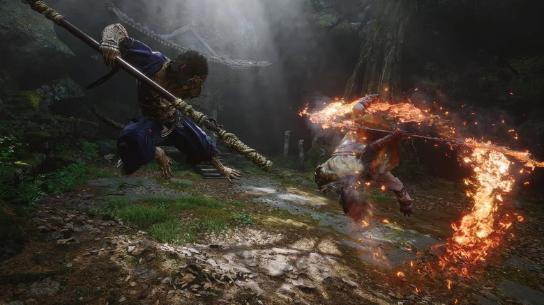 The Destined One fights an enemy with a flaming staff in "Black Myth: Wukong" (2024)