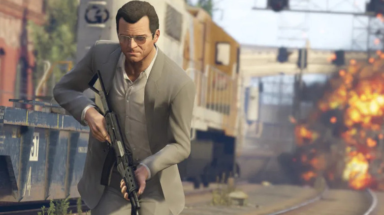 Michael De Santa walks away from an explosion while holding an assault rifle in Grand Theft Auto 5