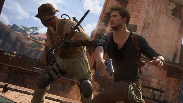 Nathan Drake punching an enemy in Uncharted 4: A Thief's End